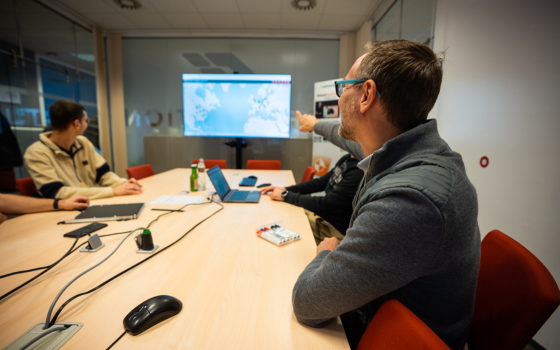 Team at a meeting, worldmap in the background